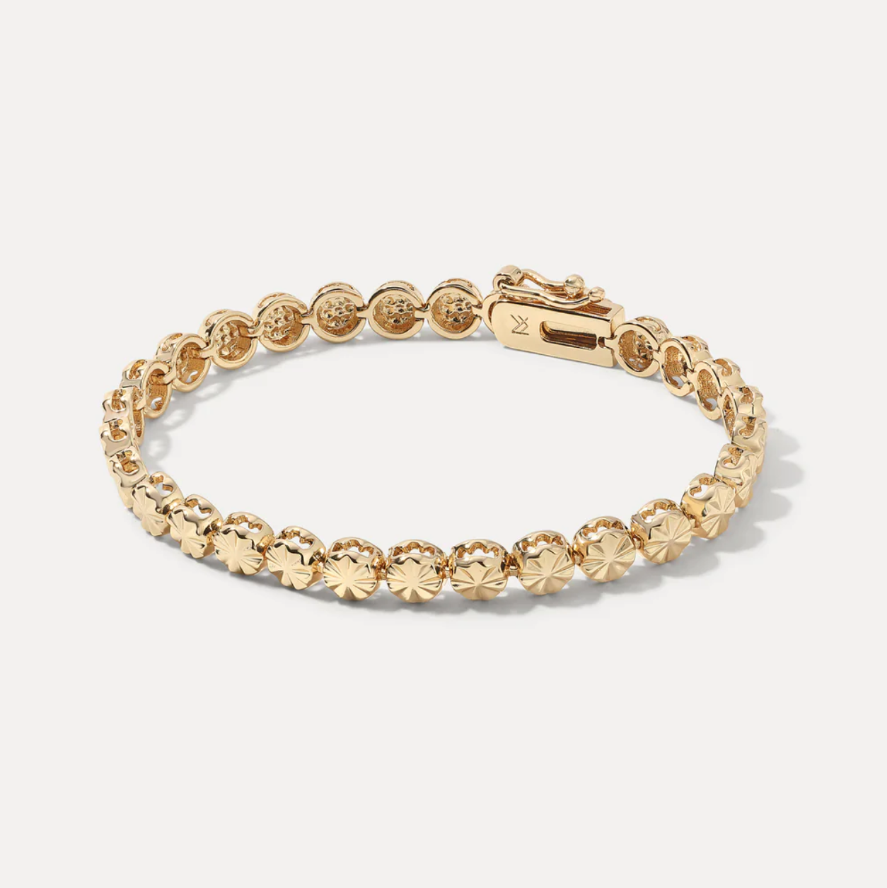 Gold bracelet with vintage star-shaped beads on a white background
