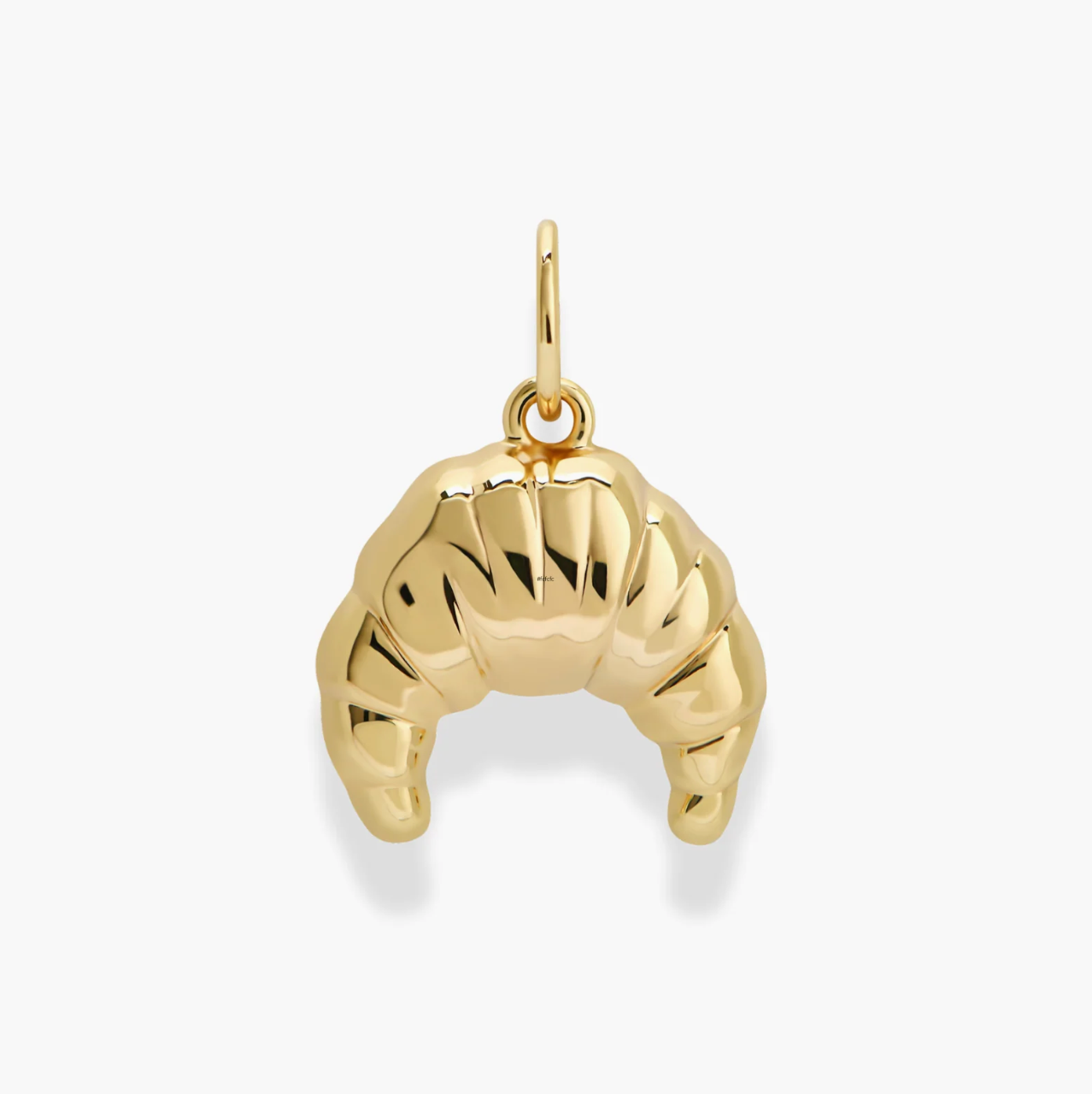 Gold croissant pendant on a white background