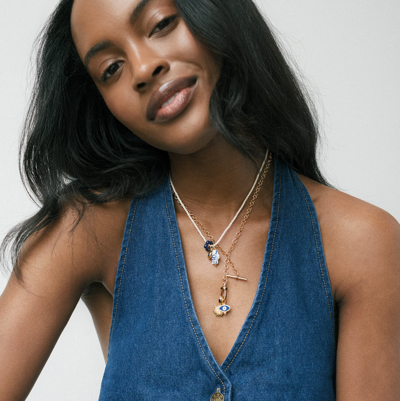 Enameled gold plated evil eye charm on model