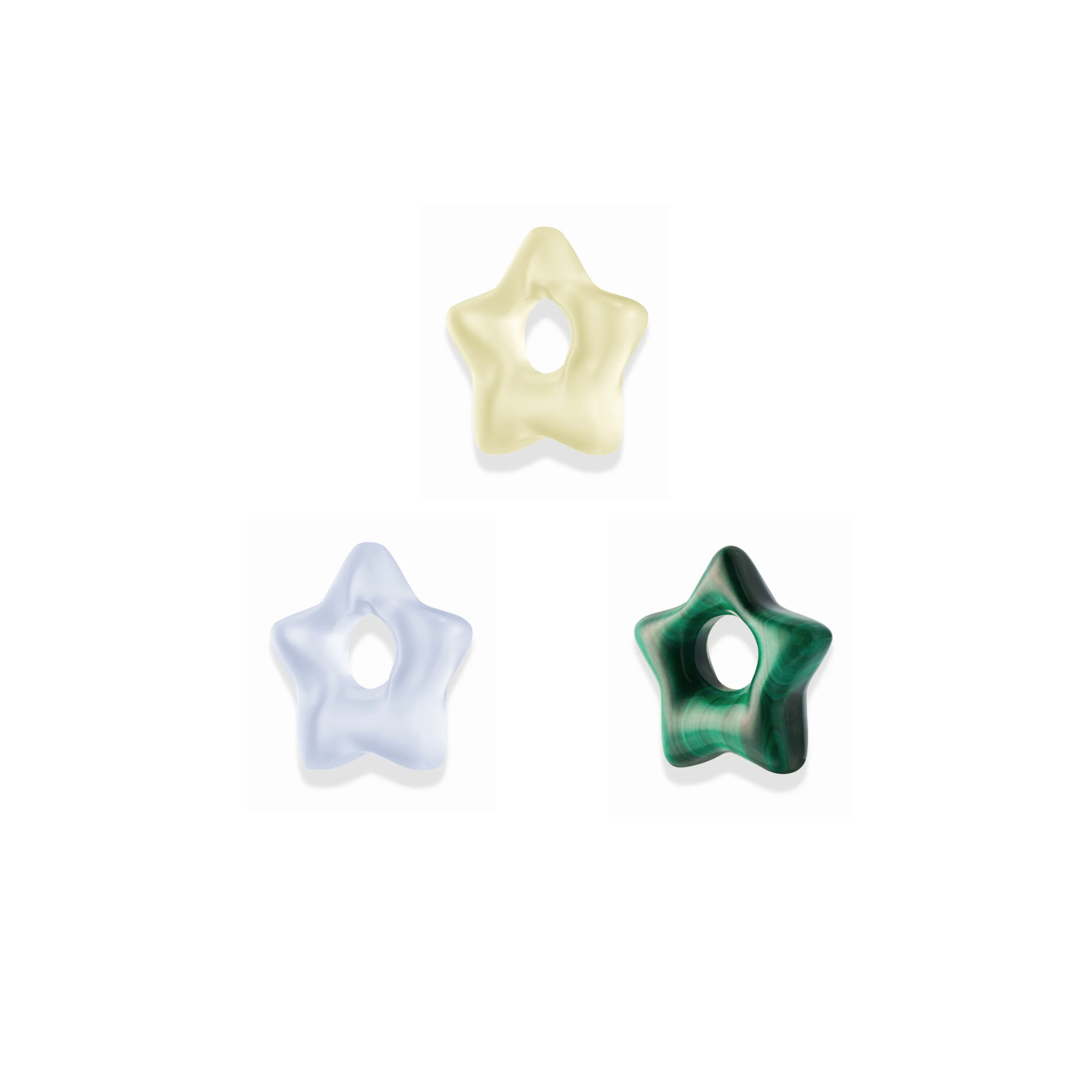 three star shaped gemstone spacer charms in different colors over a white background