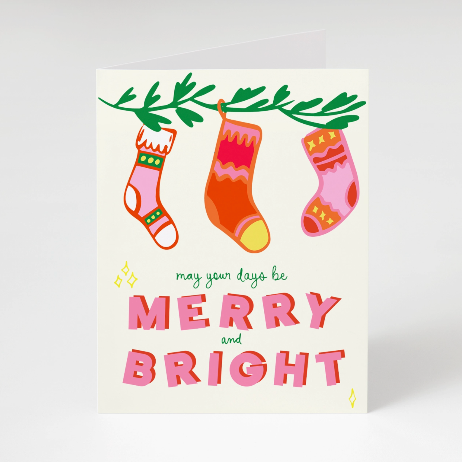 White greeting card with pink and red stockings on white background