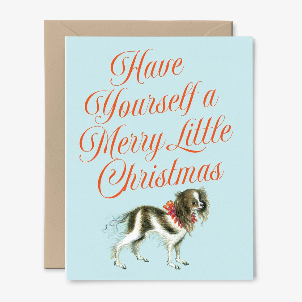 Christmas card with a dog illustration and text 'Have Yourself a Merry Little Christmas' on a light blue background.