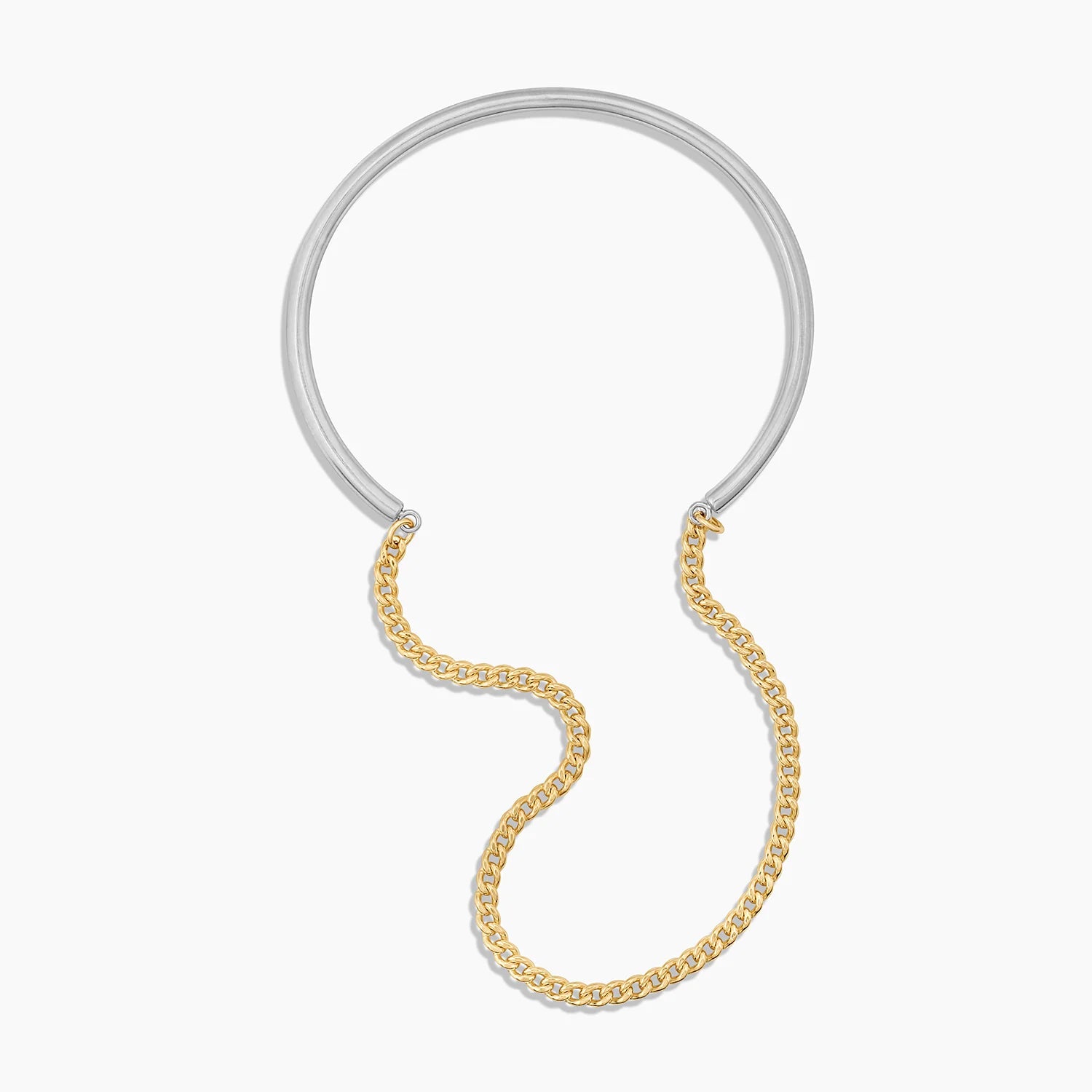 a silver cuff and gold chain on a white background