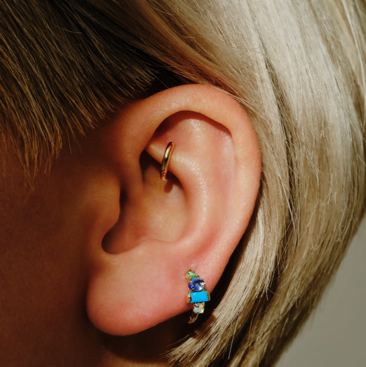 Introducing our timeless Multi Claw Gemstone Clicker Hoops, a must-have addition to our Core collection. These exquisite hoops come in five captivating multi gemstone options, showcasing the beauty of claw-set gemstones in oval, round, baguette and pear shapes, adding elegance and sophistication to your earring story.