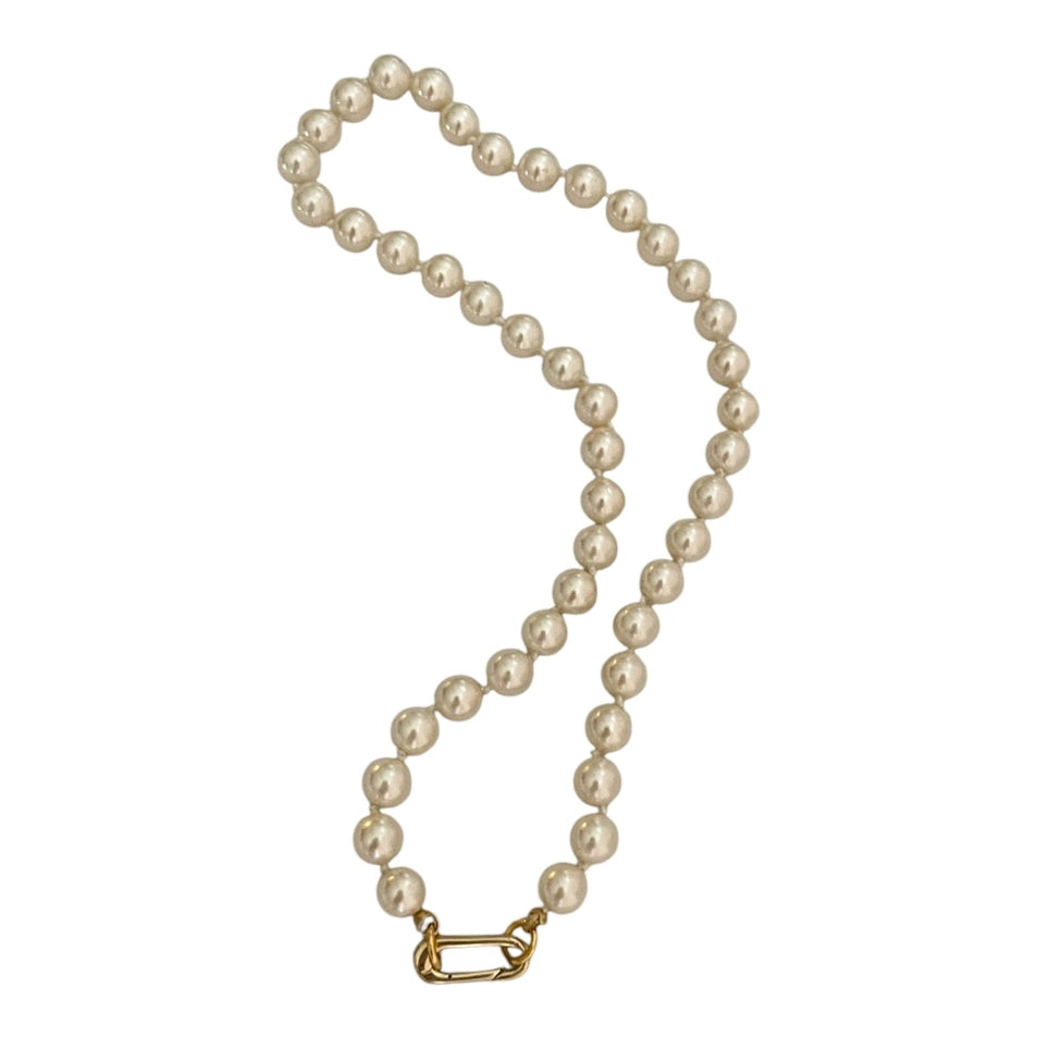 Pearl necklace with gold clasp on white background