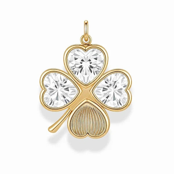A gold shamrock pendant featuring three heart-shaped clear gemstones and a ribbed bottom leaf, shown on a clean white background.