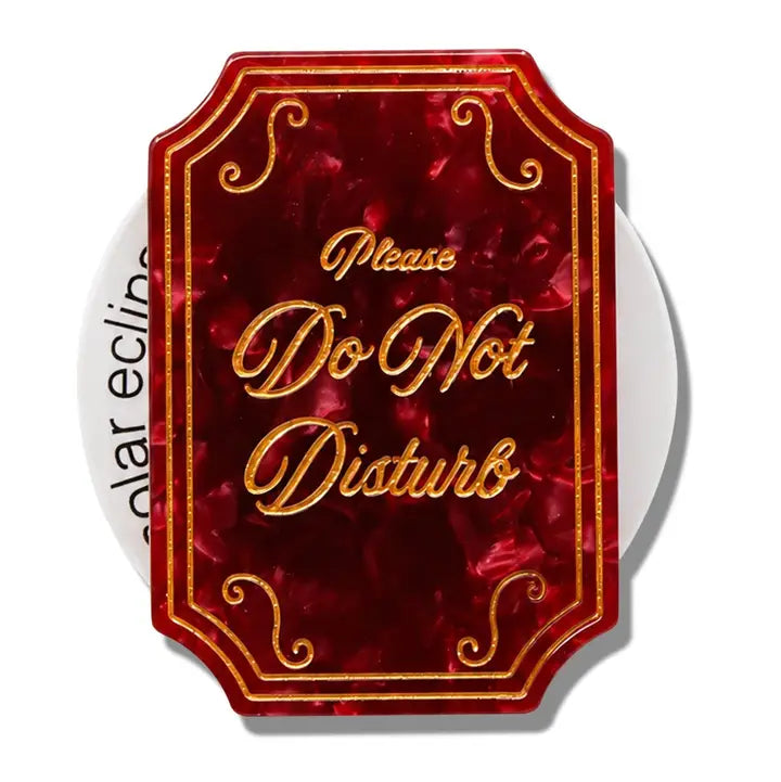 a multitoned rectangle with ornate text reading please do not disturb in gold lettering 