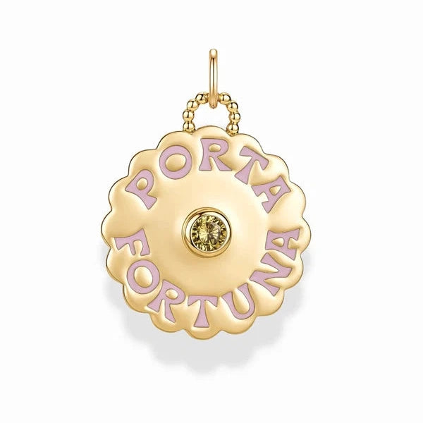 A gold-tone circular pendant charm with scalloped edges, featuring the words 'PORTA FORTUNA' in raised gold lettering with lavender enamel fill, and a small round clear gemstone at the center, suspended from a gold chain on a white background.