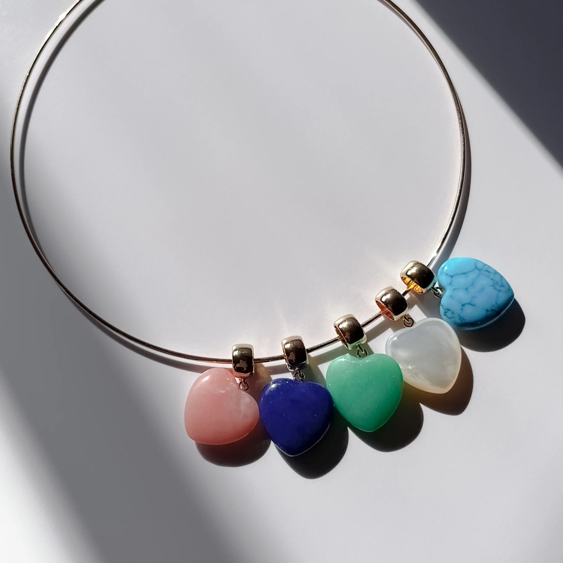 Necklace with colorful heart-shaped beads on a light background
