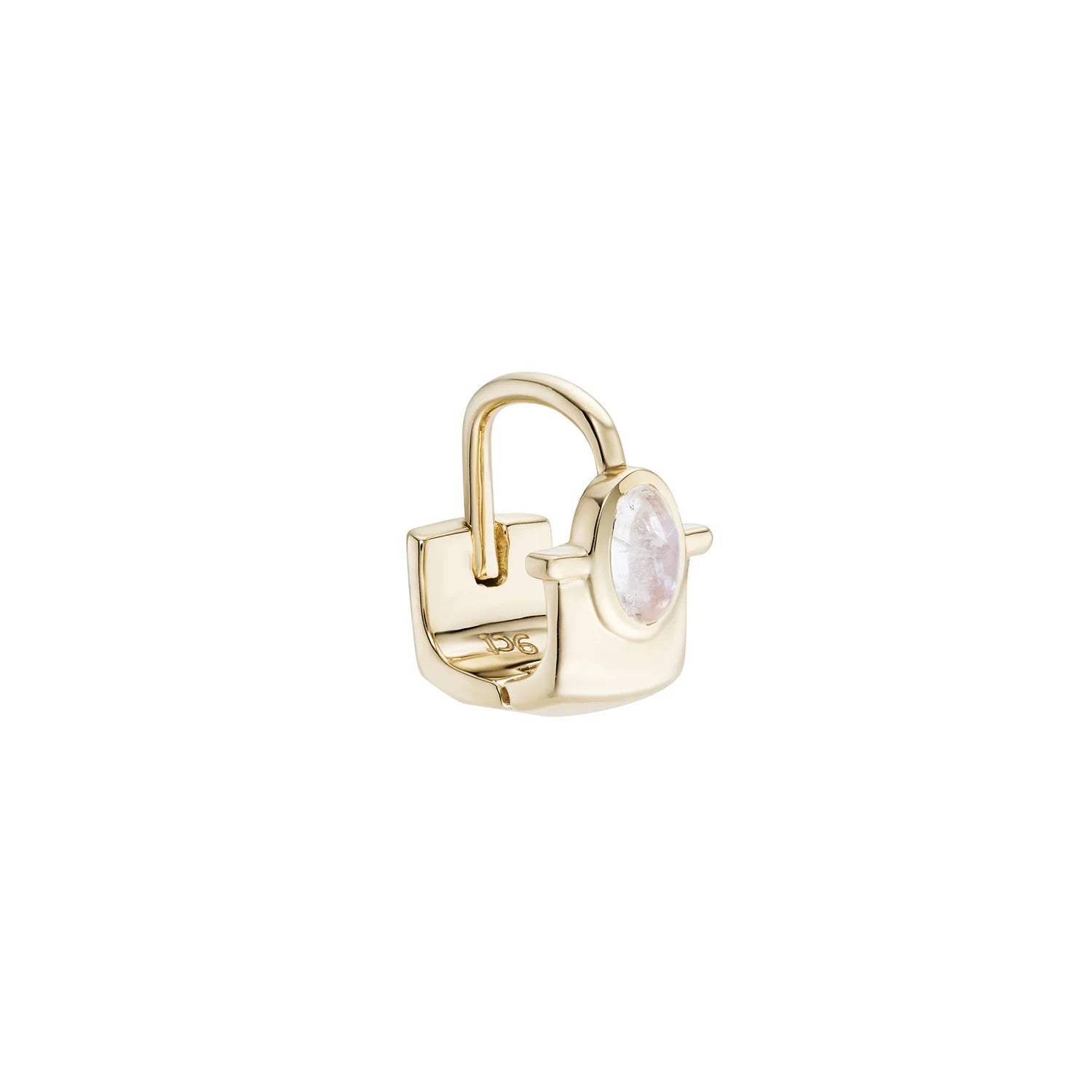 a gold cuff earring with a large bezel set moonstone rondelle over a white background