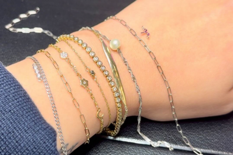 Dainty permanent bracelets and with Salt + Pepper diamond charms, styled in a layered Brave Daughters stack.