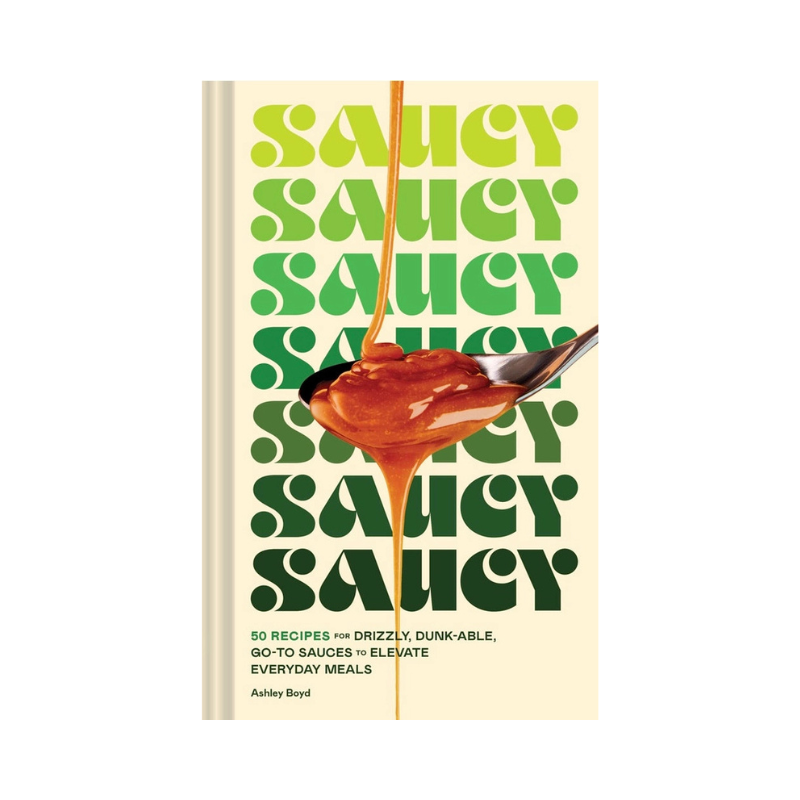 Book cover of 'Saucy' with green text and a spoonful of sauce on a beige background