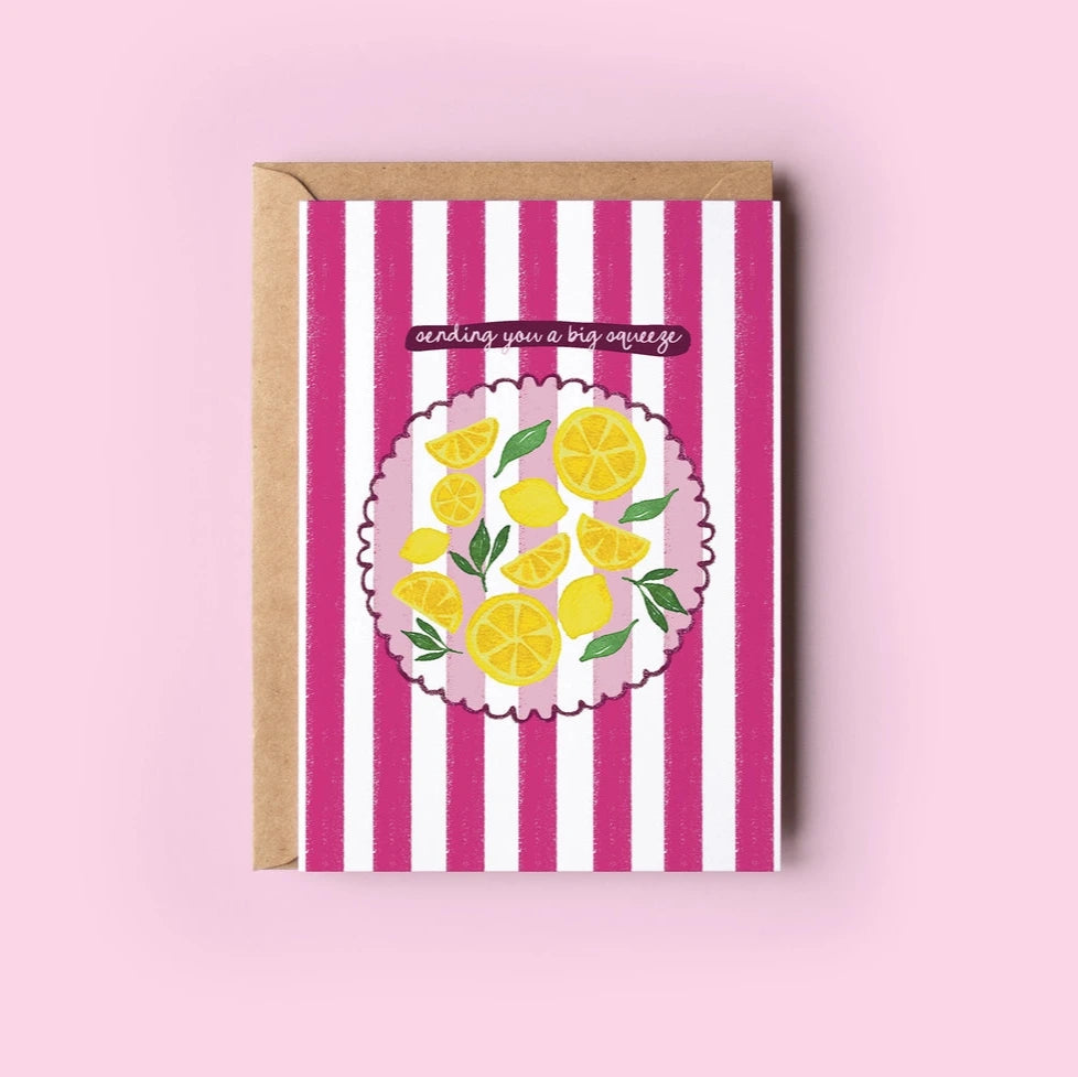 Greeting card with lemon design and pink stripes on a pink background