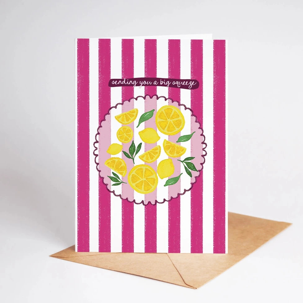 Greeting card with pink stripes and lemon design, featuring a brown envelope.