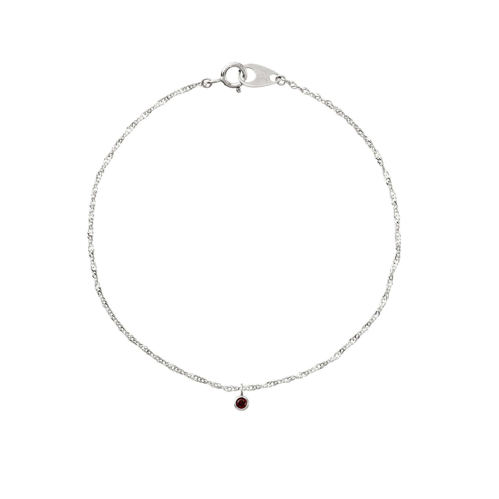Silver bracelet with a red gemstone on a white background