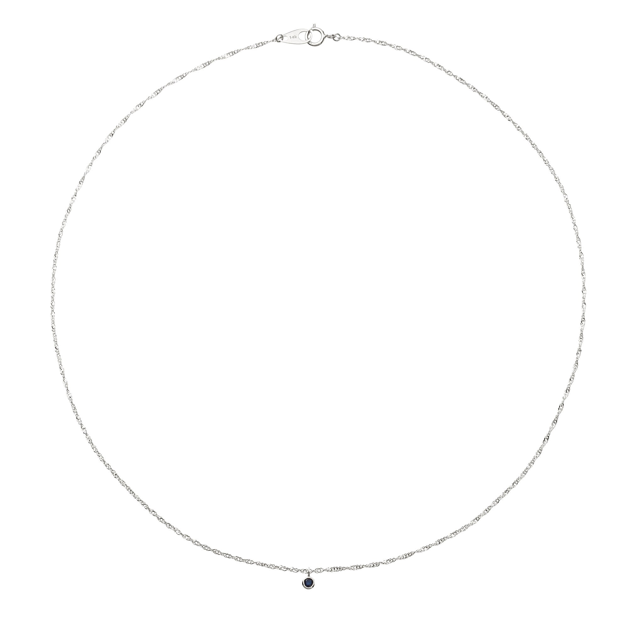 Silver necklace with a small black pendant on a white background