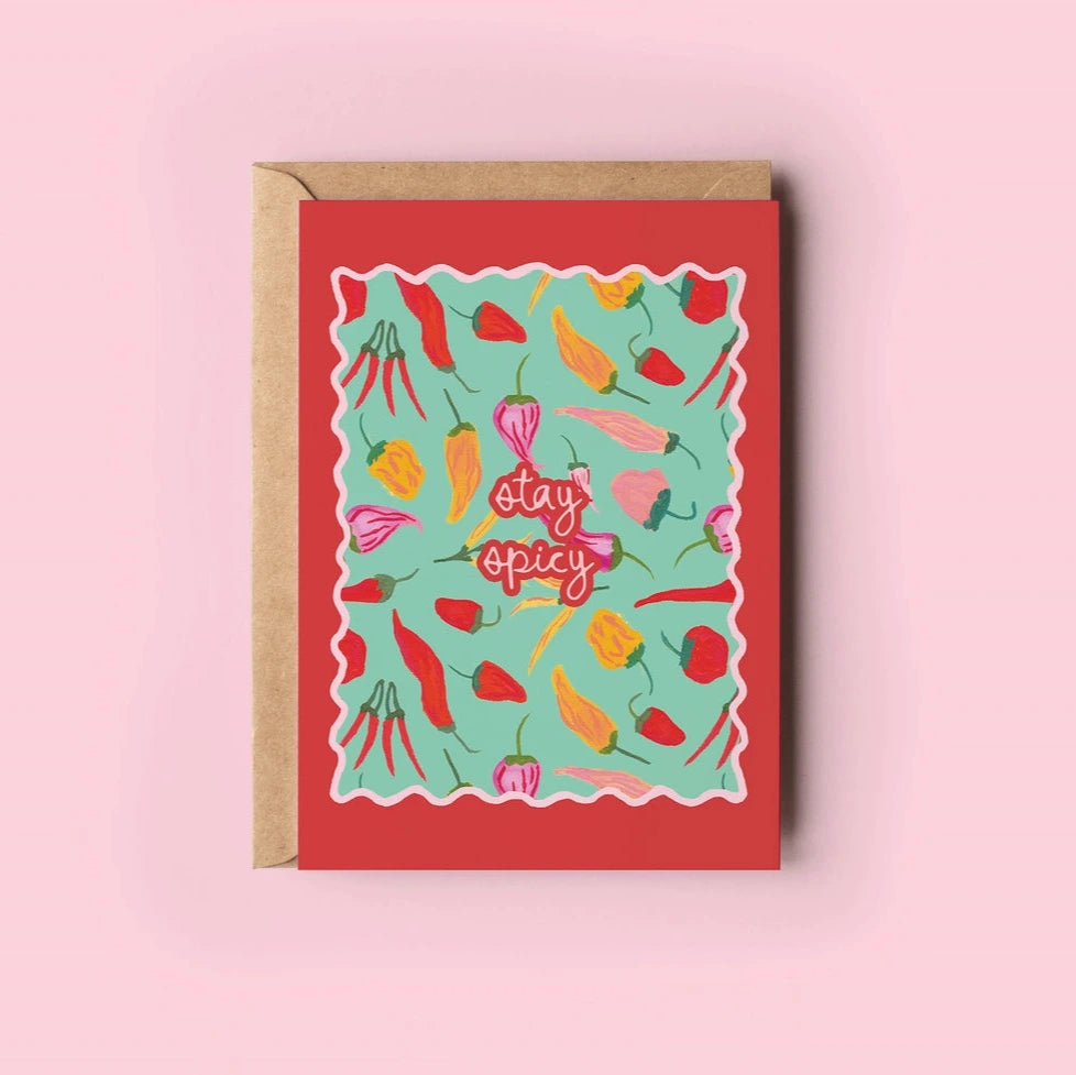 Greeting card with vegetable illustrations and 'stay spicy' text on a pink background