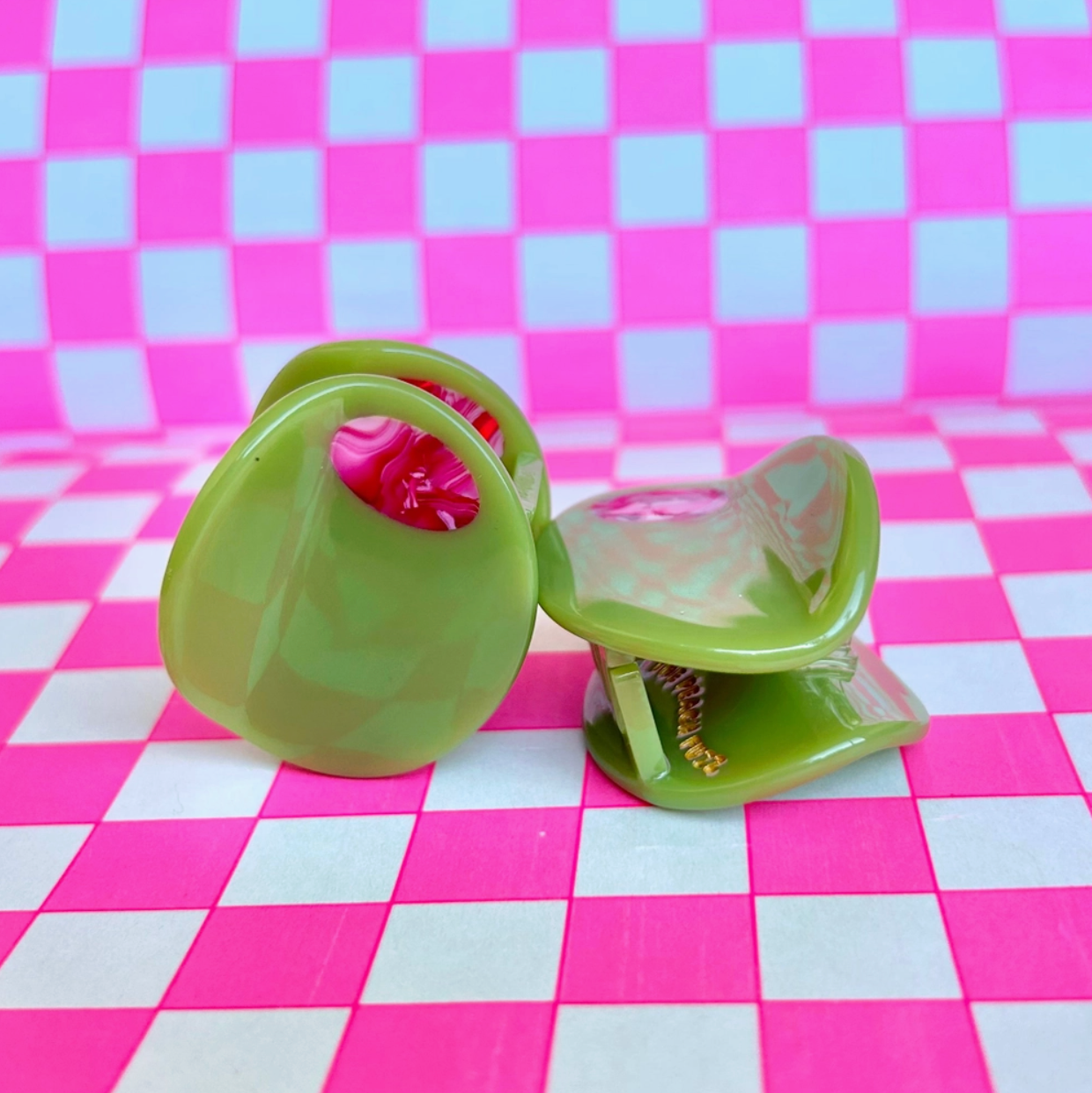 Olive shaped clips on checkered pink background
