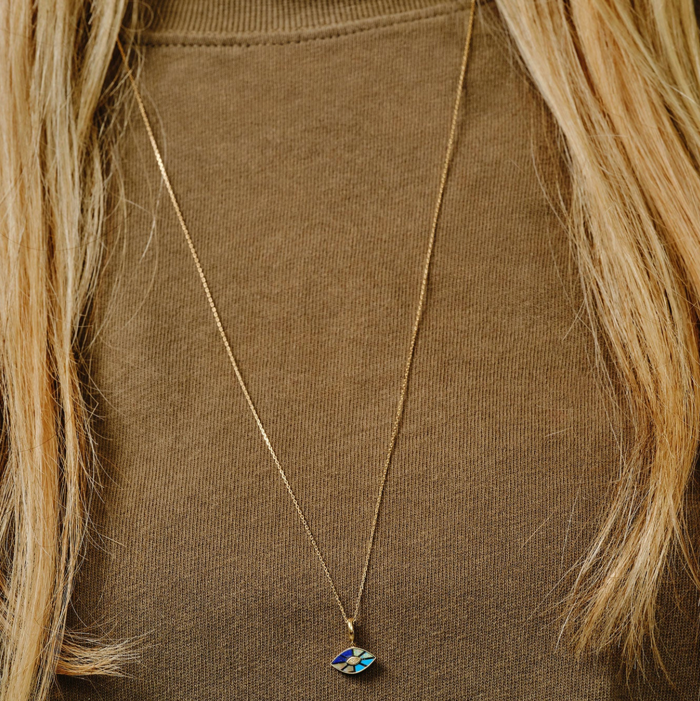 Multi Gemstone Evil Eye Pendant on chain on a model