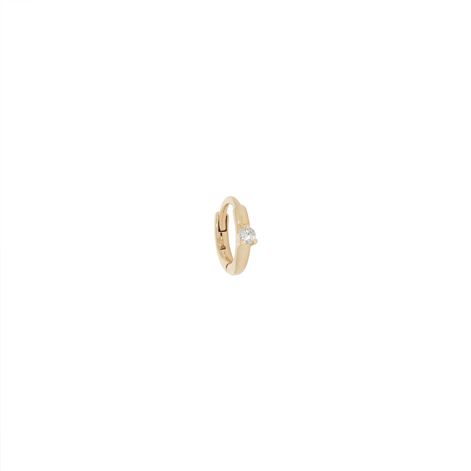 a gold hoop earring with a hinge back closure and three prong set white diamond over a white background