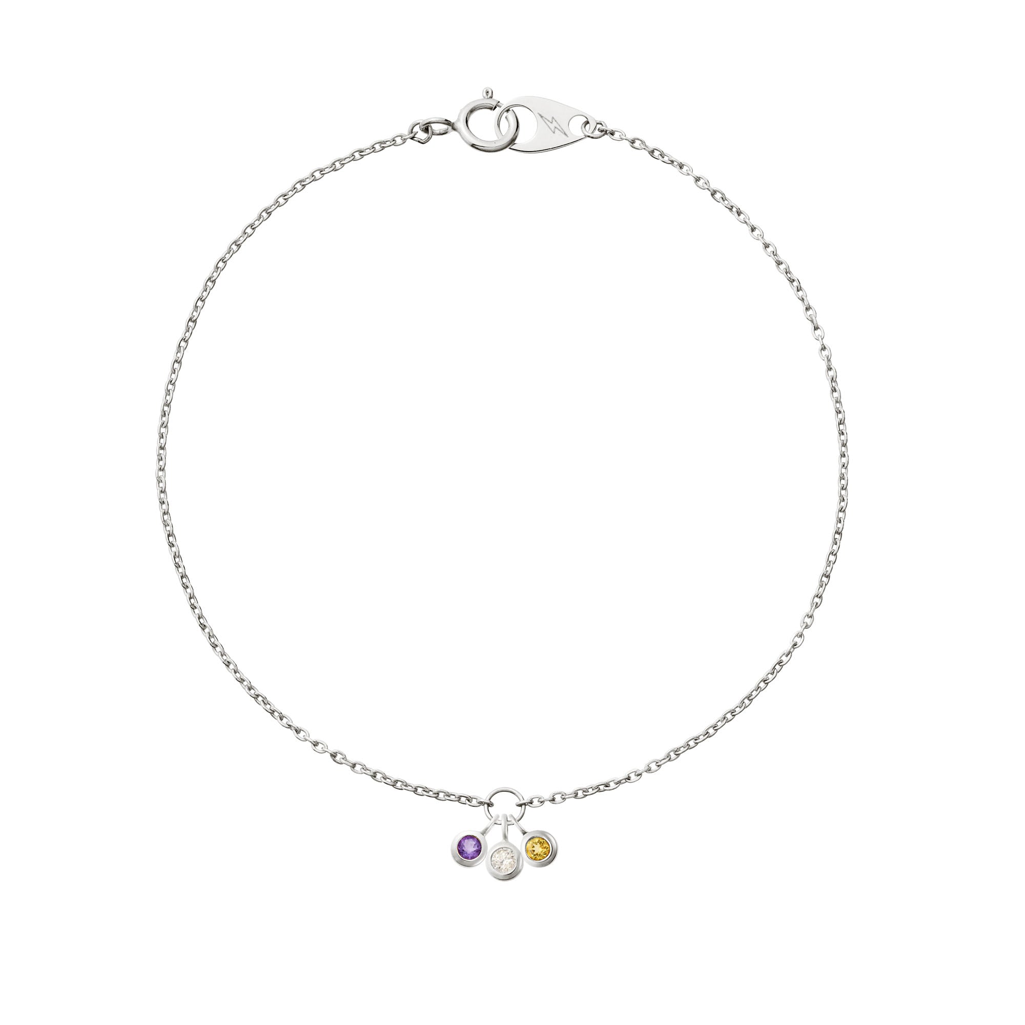 Three delicate hanging 14k white gold birthstones on a 14k white gold mini cable bracelet on white background