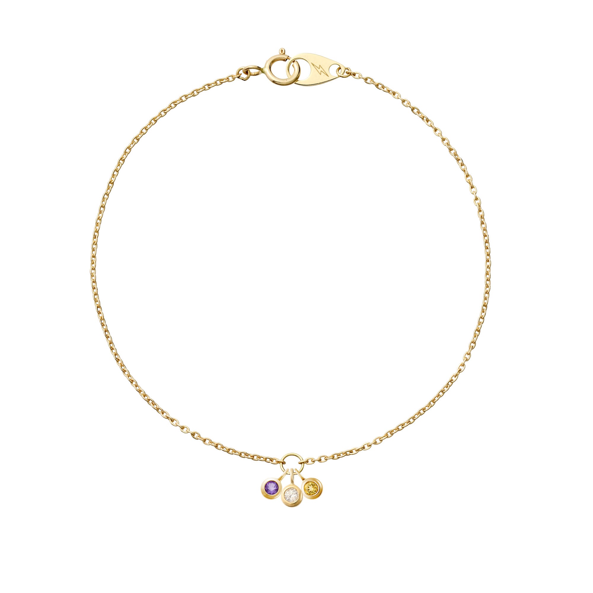 Three delicate hanging 14k yellow gold birthstones on a 14k yellow gold mini cable bracelet 