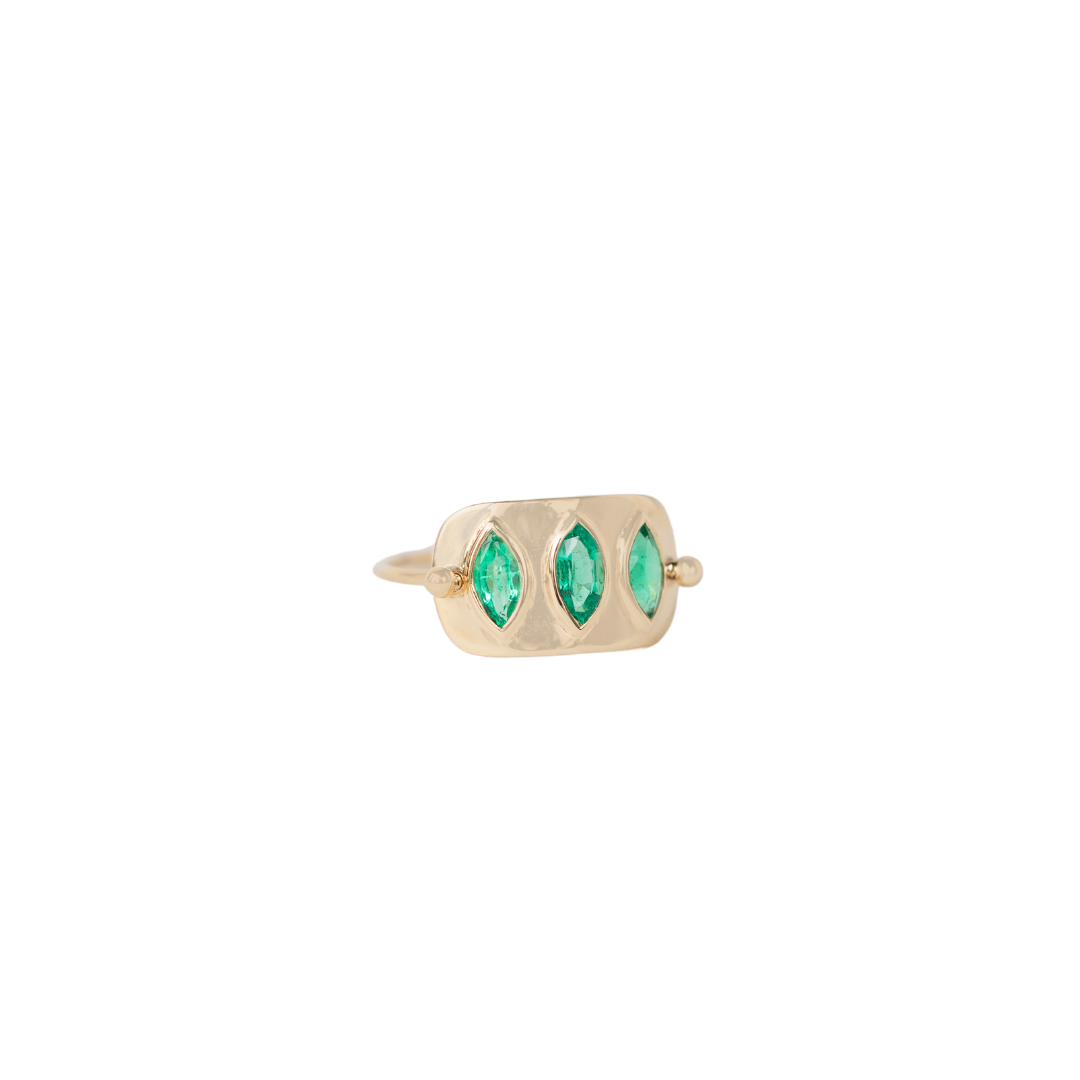 14K solid yellow gold ring with 1 × 1.7 cm gold plate and 0.60 ct triple marquise-cut emeralds — known as the Love Stone, symbolizing harmony, compassion, and unconditional love.