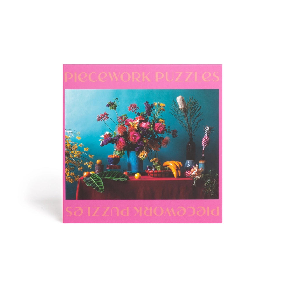 Piecework Puzzles packaging with a colorful floral arrangement on a table