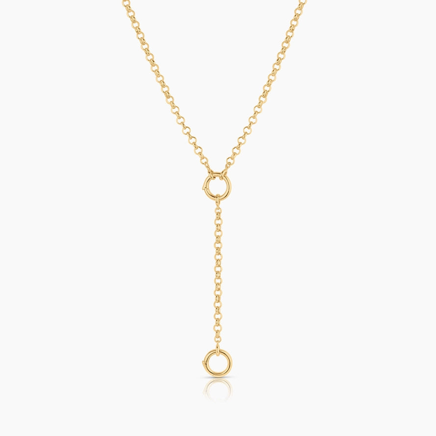 a gold rolo chain with a ring clasp attachment attached to a gold rolo chain necklace on a white background