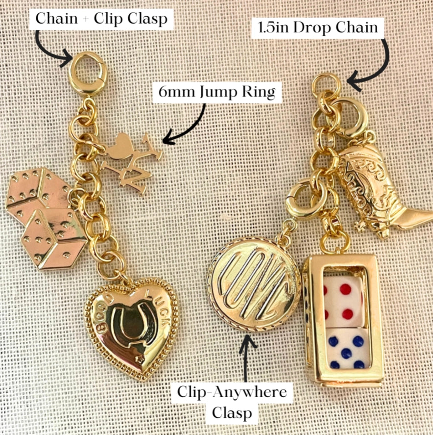 assorted gold charms and clasps on a khaki colored linen background