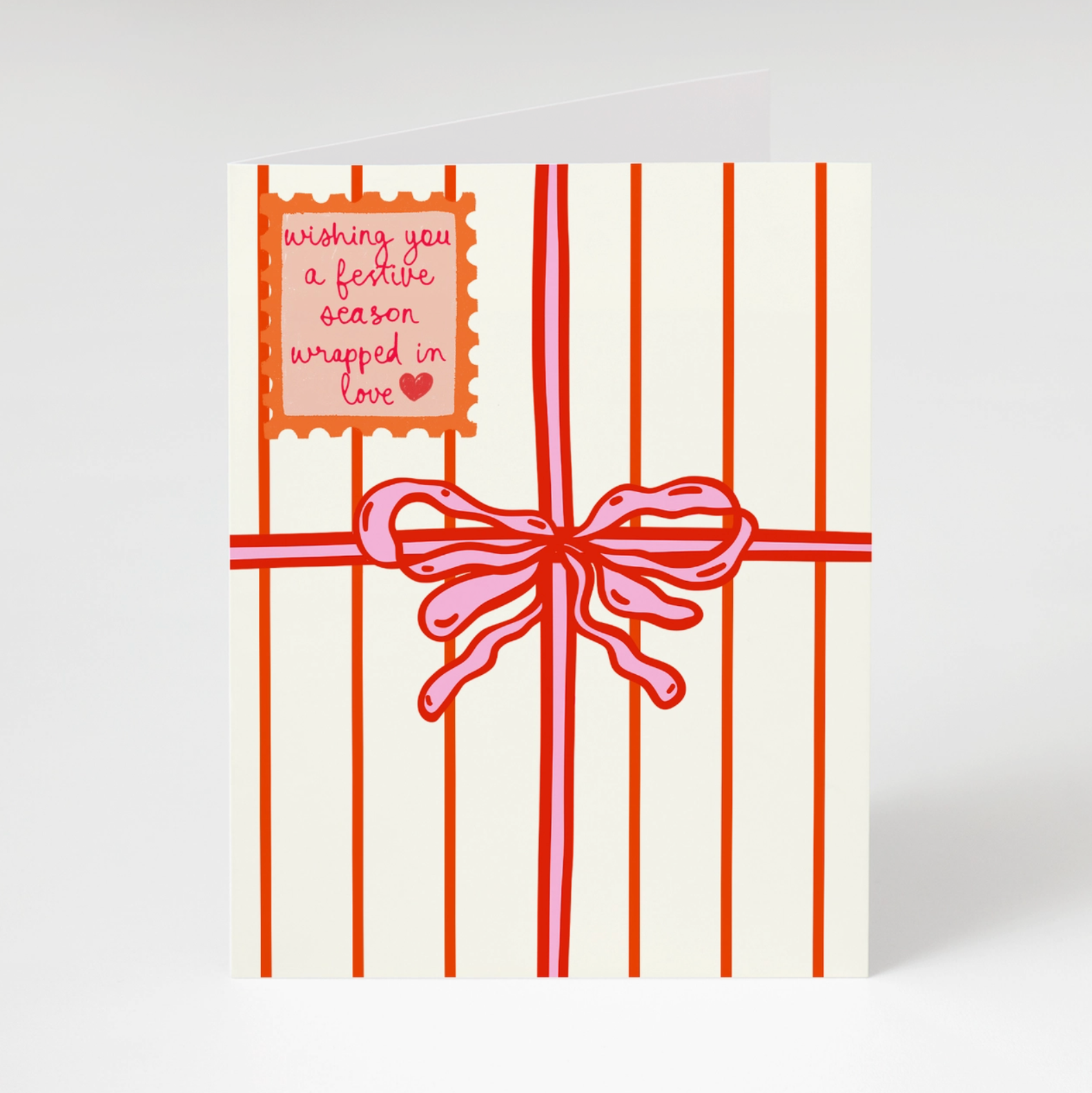 holiday greeting card that looks like a wrapped holiday gift on white background