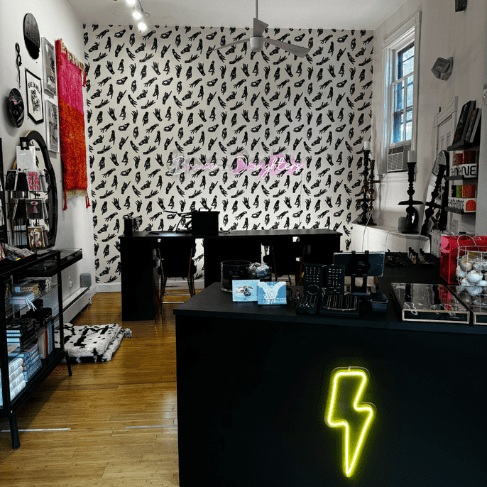 Interior of Brave Daughters Providence studio with permanent jewelry welding station and fine jewelry displays