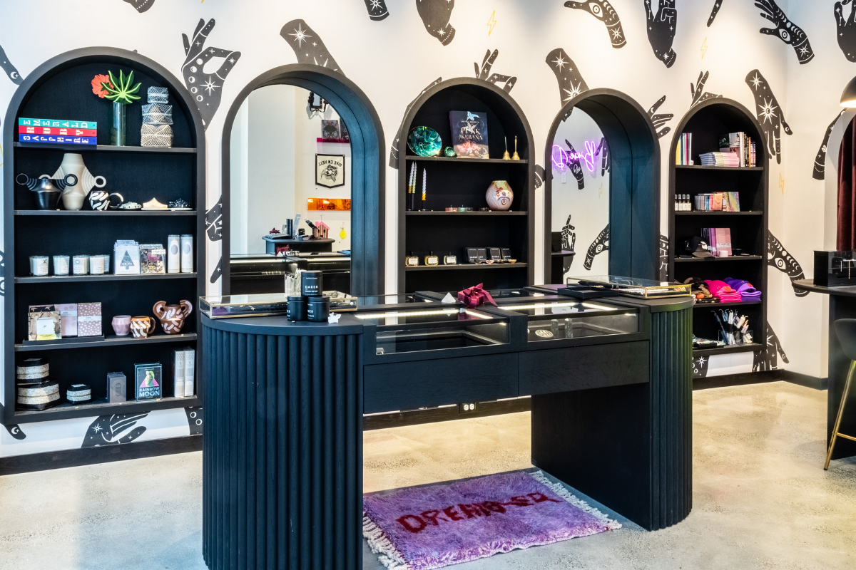 Interior of Brave Daughters Boston Seaport jewelry store featuring custom black shelving, arched displays, and fine jewelry showcases.