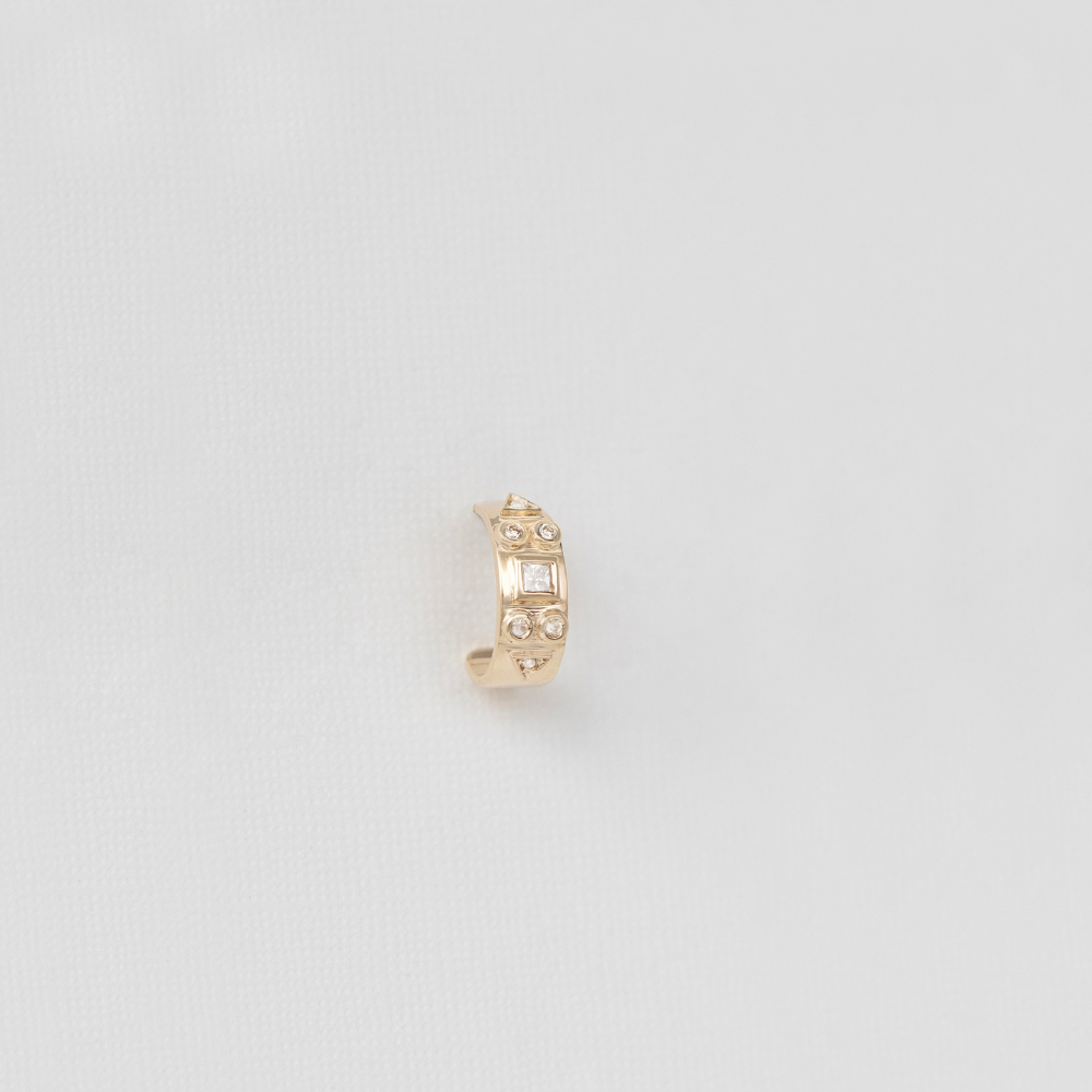 yellow gold and diamond cuff earring single stud on white background