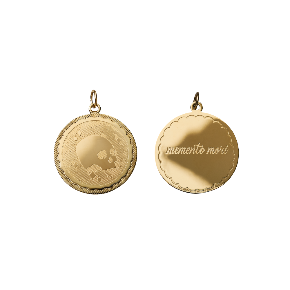 double sided engraved coin with a skull on one side and memento mori on the other side on white background