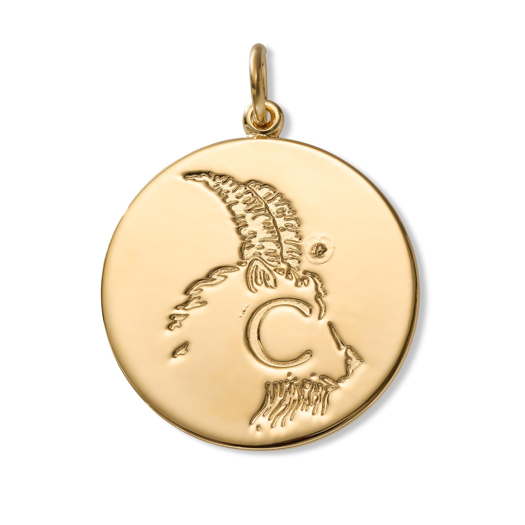 A round gold pendant featuring an engraved profile of a ram, complete with a top loop, shown on a plain white background.