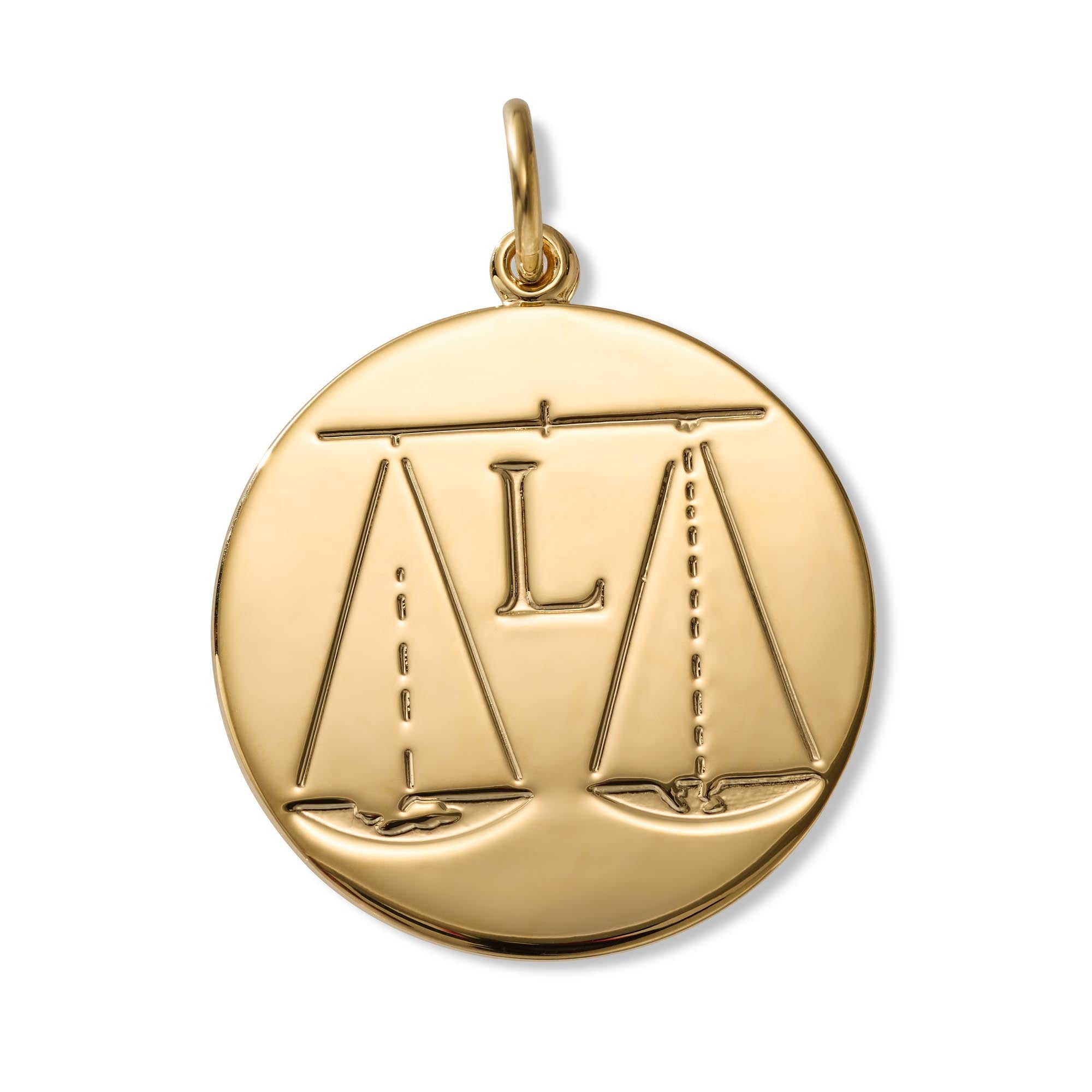 A round gold pendant engraved over a balanced scale of justice design, complete with a top bail for a chain, shown on a plain white background.