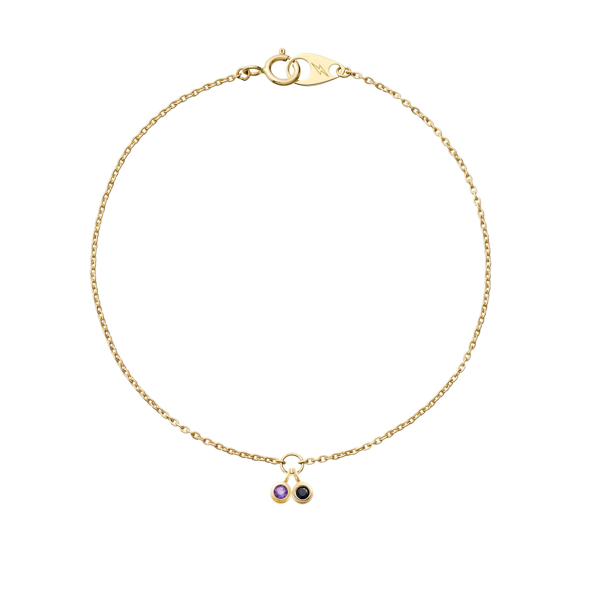 Two delicate hanging 14k yellow gold birthstones on a 14k yellow gold mini cable bracelet on a white background