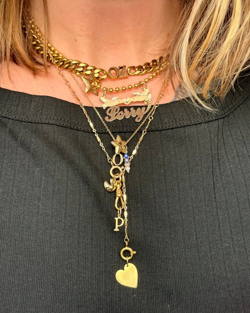 Gold-filled bar lariat necklace styled on body with a minimal layered necklace stack