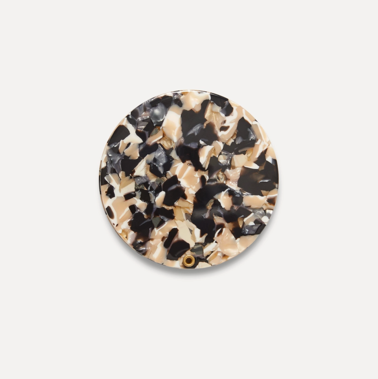 Round mirror with tortoiseshell pattern on a light gray background