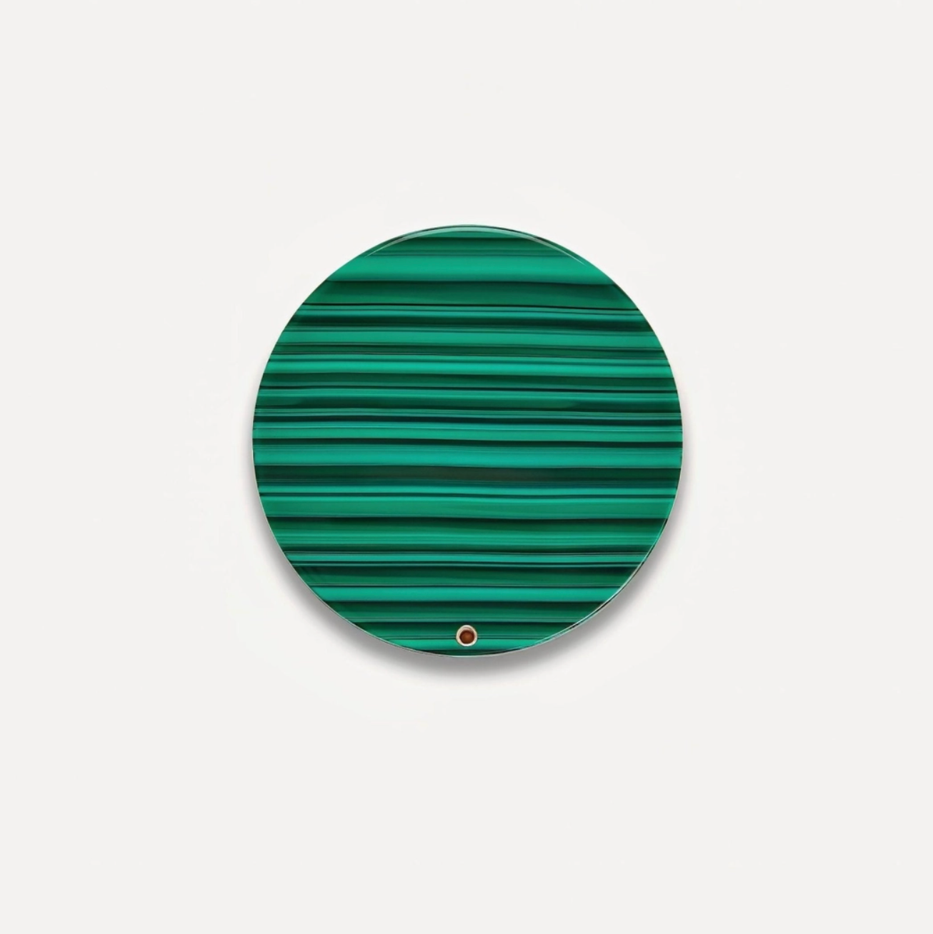 Green malachite patterned round mirror on a light gray background
