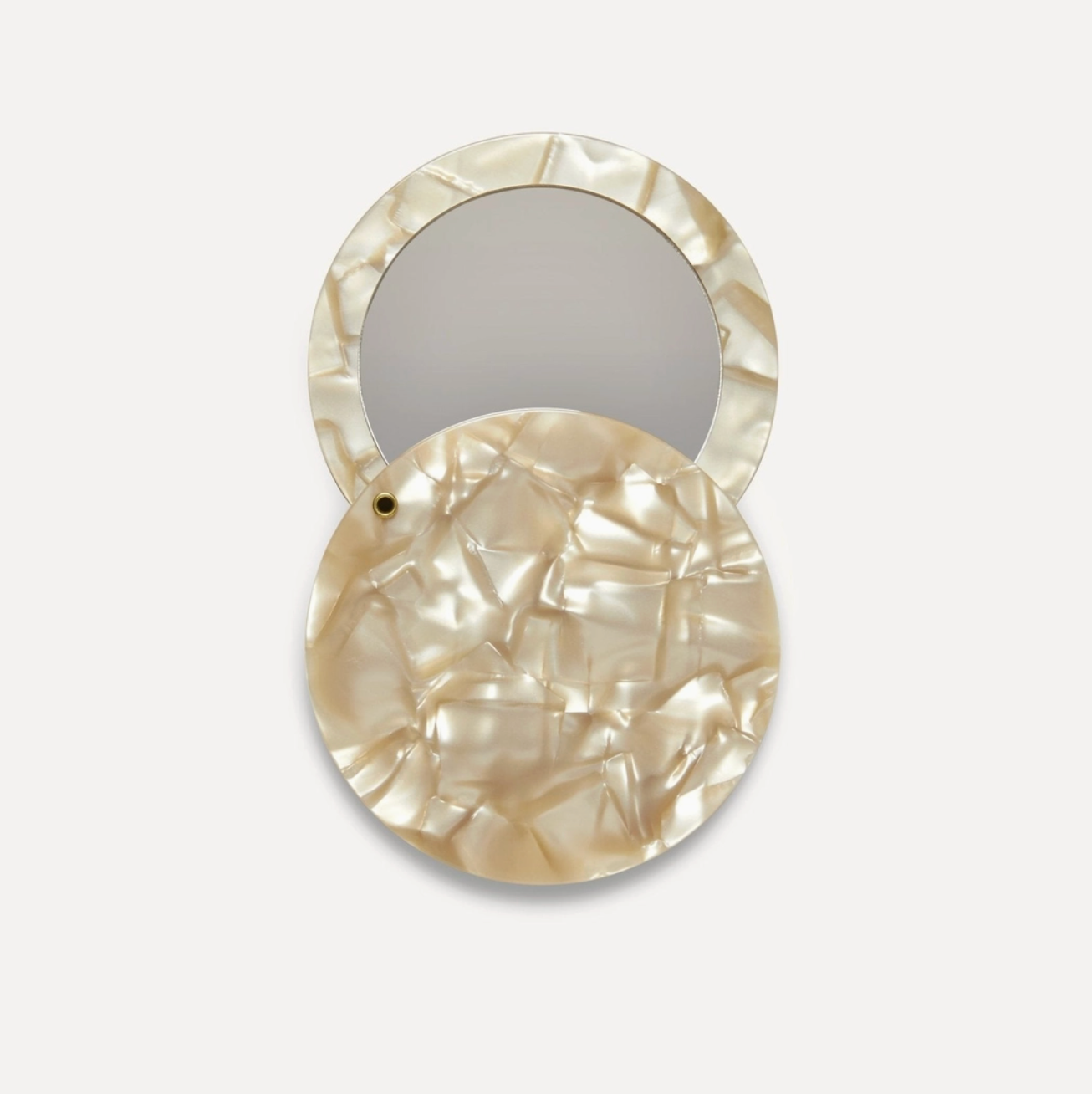 circle compact mirror in sandshell pattern on white background