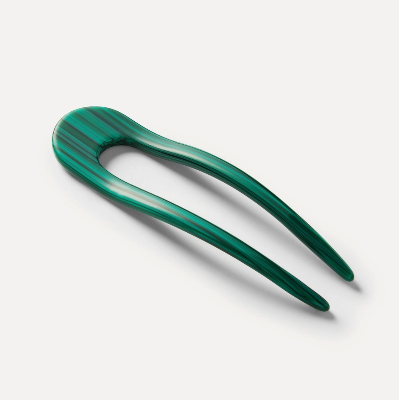 Green malachite hairpin on a white background