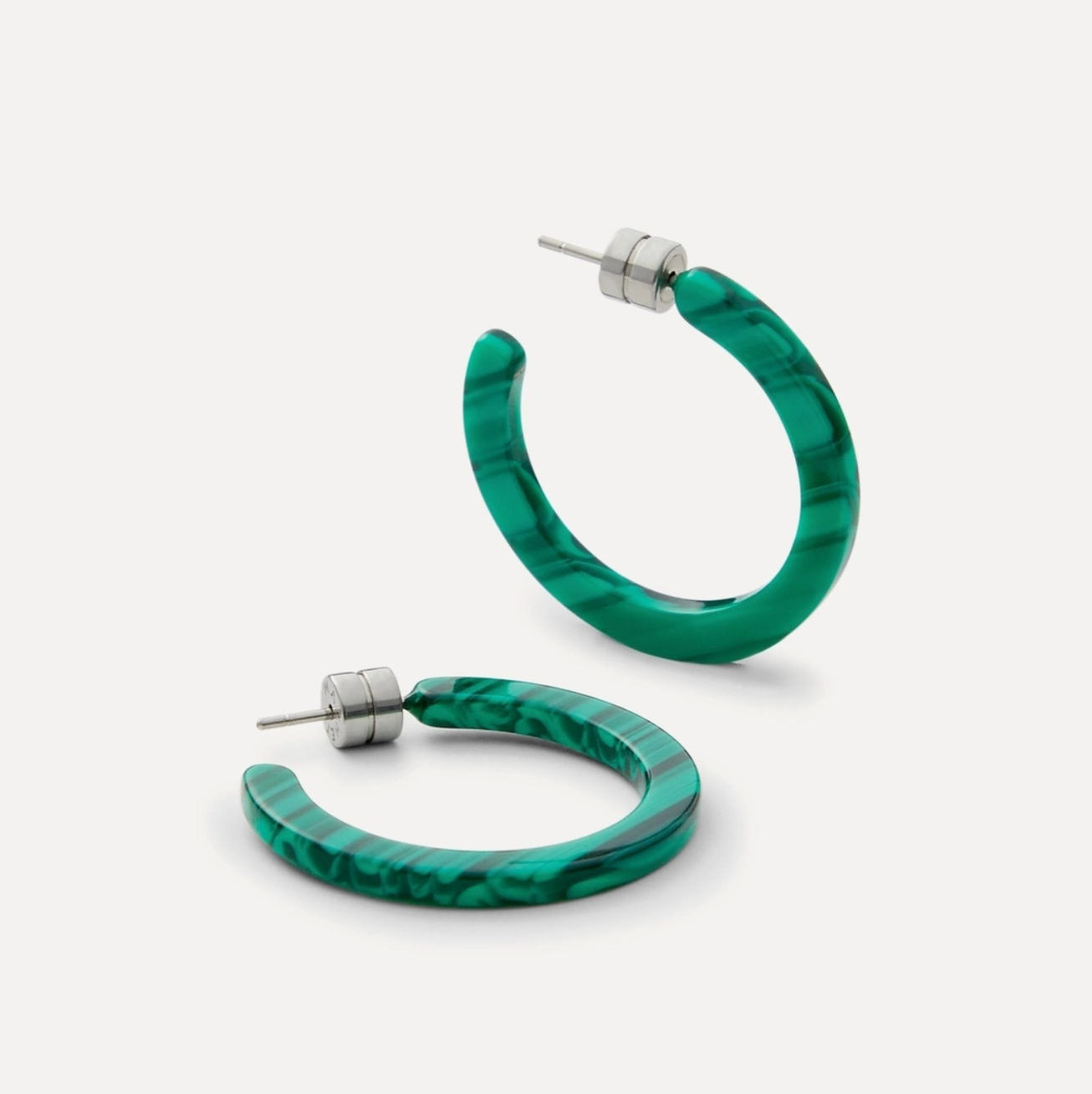 Green hoop earrings on a white background