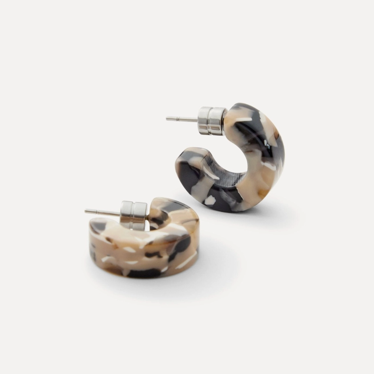 Pair of tortoiseshell hoop earrings on a white background