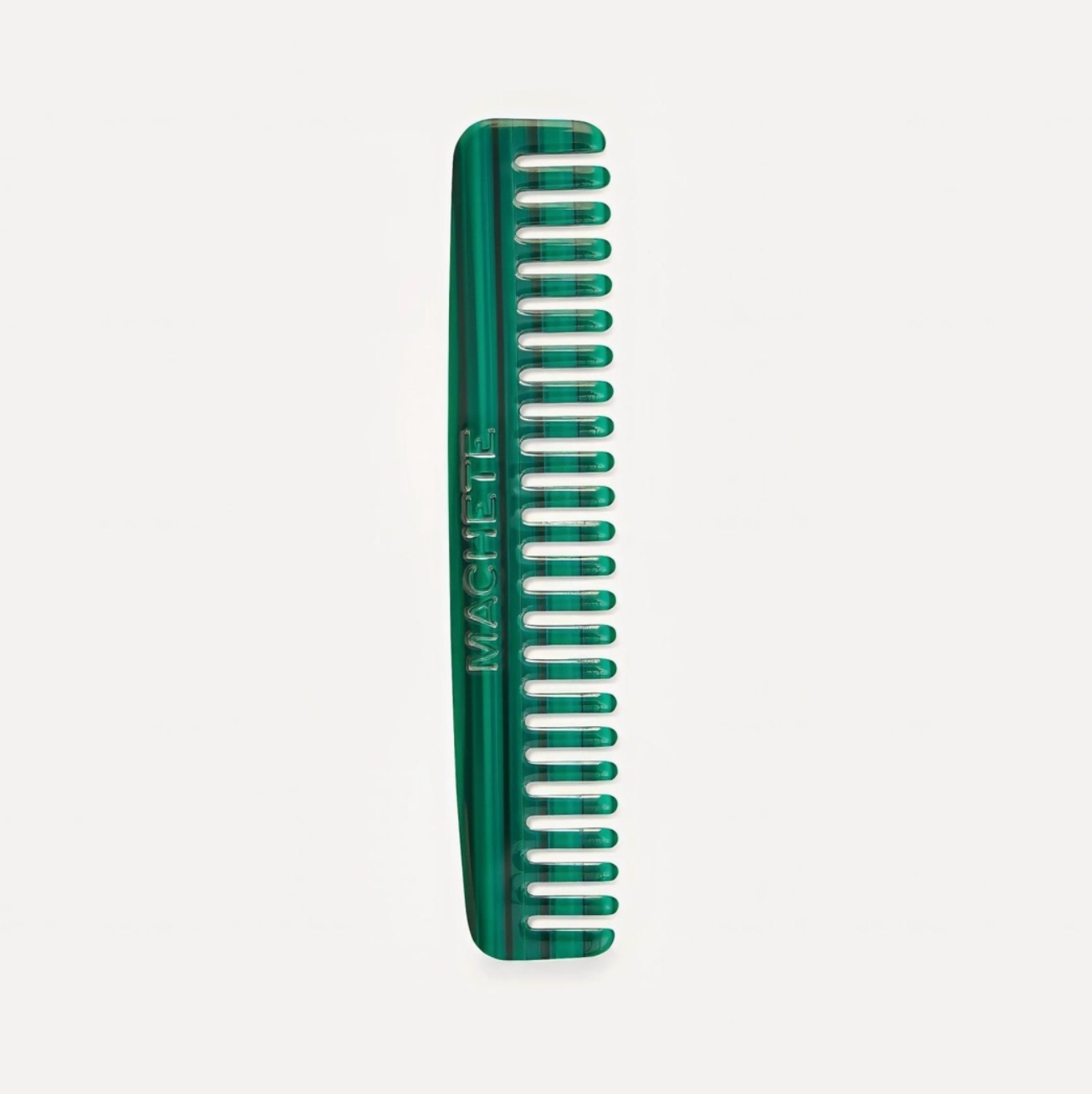 Green comb on a light gray background
