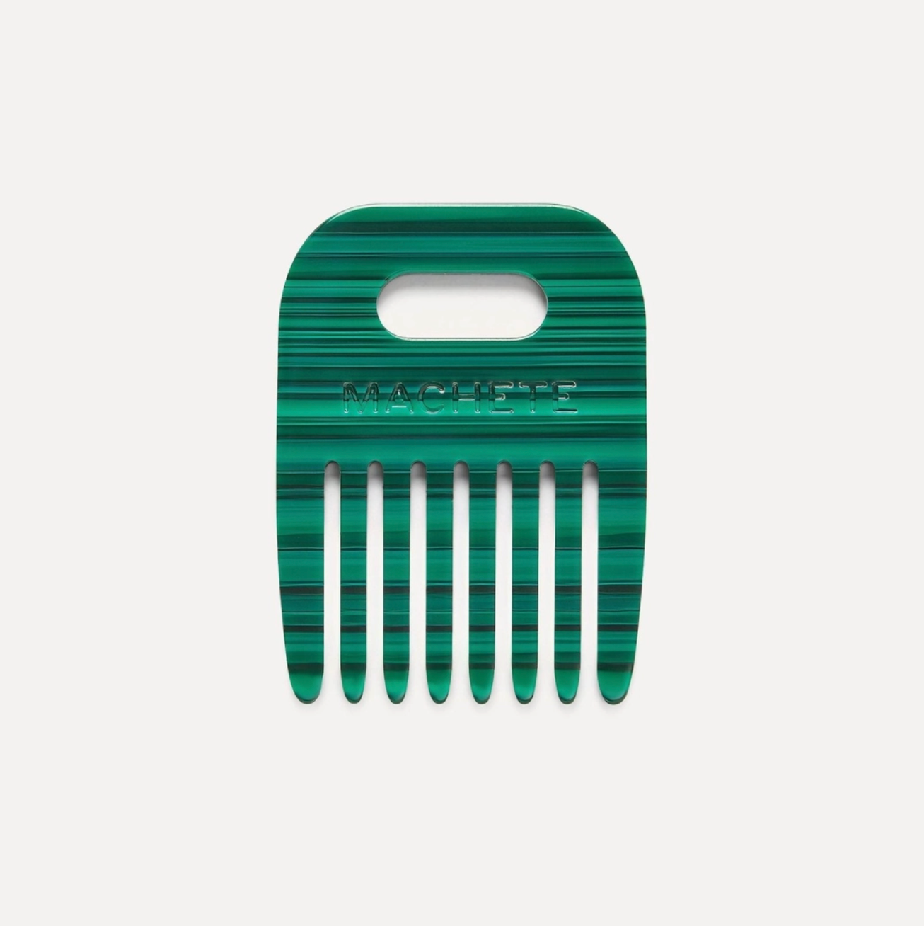 Green malachite pattern comb on a white background