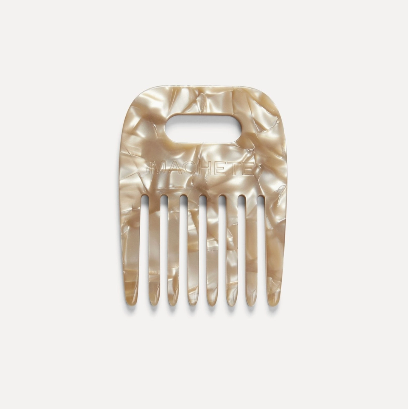 Shell-patterned hair comb on a light gray background