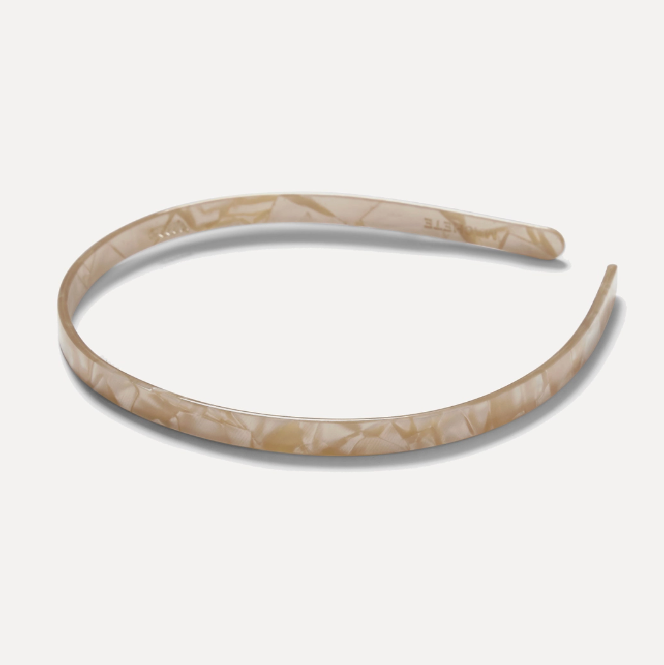Marbled beige headband on a light gray background