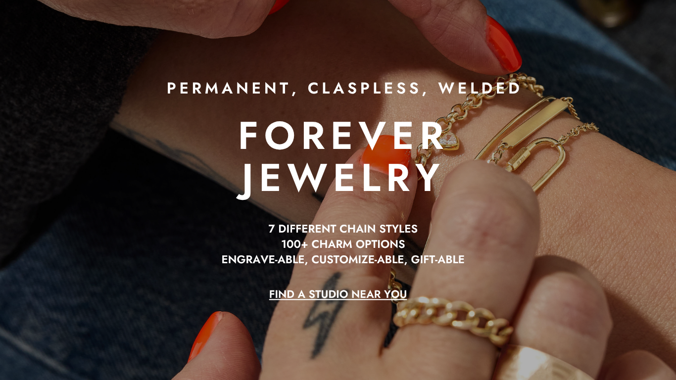 Elegant stack of fine permanent bracelets featuring solid 14k gold chains and charms, crafted by a luxury jewelry brand with studios in Boston and Rhode Island.